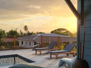 a deck with two chairs and a swimming pool at SALTY LODGE Villa 3 chambres piscine "ALIZES" - Pointe Faula in Le Vauclin