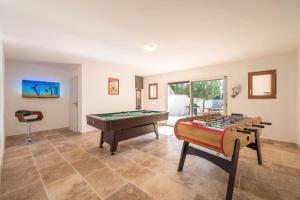 a living room with a pool table and a table at Vacation rental with pool and Jacuzzi, close to Arles - sleeps 10 in Arles