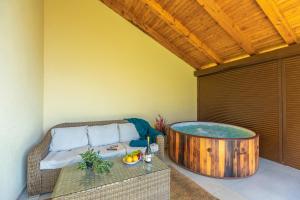 a room with a hot tub on a patio at Casa Verde and Casa Blue in Janja Gora