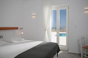 Un dormitorio con una cama y vista al mar. en Avlia Panoramic Villa Naxos, en Naxos Chora