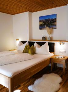 a bedroom with two beds with pillows at Ferienhaus Bucheggerhof in Schladming