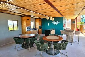 a room with two tables and chairs and a kitchen at Rooftop Tamandaré by Temporada Inn in Tamandaré
