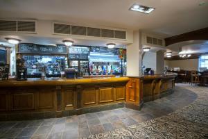 a bar in a restaurant with a lot of alcohol at The Wyndham Arms-Wetherspoon in Bridgend