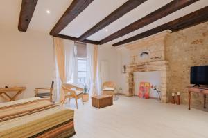 a bedroom with two beds and a fireplace at Gite d'ici et d'ailleurs in Brantôme
