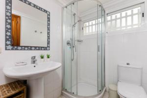 a bathroom with a shower and a sink and a toilet at Yourhouse El Xiprer in Pollença +21 photos