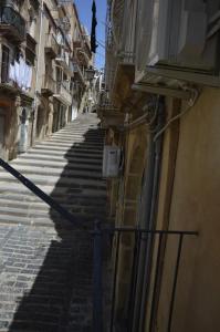 卡尔塔吉罗Modern Apartment in Caltagirone, 40 m² with Balcony的两栋建筑之间陡峭的楼梯小巷