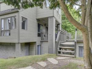 a house with a staircase in front of it at Charming Condo in the Mont Tremblant Ski Village in Mont-Tremblant +6 photos