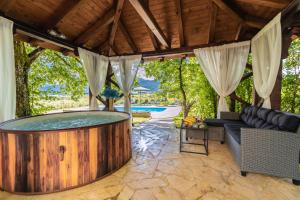 a hot tub in the middle of a patio at Villa Hills in Janja Gora