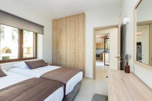 a bedroom with two beds and a large window at Upper View Villa, with private pool in Chania +68 photos