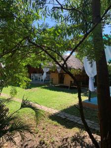 a view of a house with a bench in the yard at VitaminSea Room in Dauin