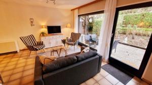a living room with a couch and chairs and a television at LittleHome in Gerolstein +27 photos