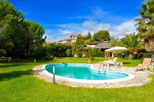 a swimming pool in the yard of a house at Villa Ninfea in Mascalucia