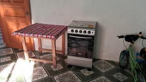 a kitchen with a stove and a table in a room at Axel Casa in Jaibalito