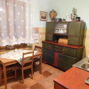 a kitchen with a table and a dining room at Birkut Szkoła Przetrwania 1 in Lasowka
