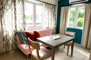 a living room with a table and a couch at Numero Uno Beach Apartments in San Juan