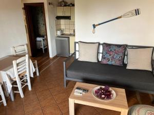 a living room with a couch and a table at Villa Maraki in Agia Paraskevi