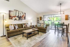 a living room with a couch and a table at Golf Course On-Site Peaceful Condo in Palm Desert in Palm Desert