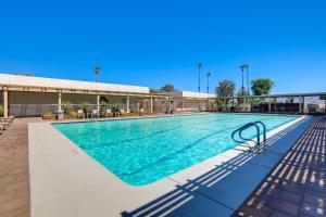 a swimming pool at a resort with blue water at Golf Course On-Site Peaceful Condo in Palm Desert in Palm Desert