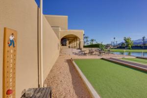 a building with a tennis court on the side of it at Golf Course On-Site Peaceful Condo in Palm Desert in Palm Desert