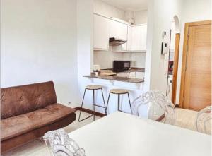 a living room with a couch and a table and chairs at 2 Habitaciones con vistas y 2 Terrazas en Primera Linea Playa Samil in Vigo