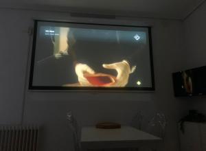 a projection screen on a wall with a man on it at 2 Habitaciones con vistas y 2 Terrazas en Primera Linea Playa Samil in Vigo +20 photos