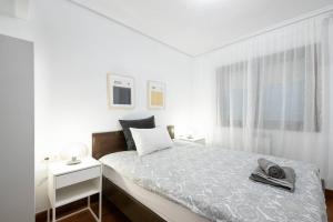 a bedroom with a bed with a pair of shoes on it at Apartamento agradable con parking en Gros in Donostia-San Sebastián