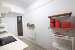 a kitchen with white walls and red appliances at Apartamento agradable con parking en Gros in Donostia-San Sebastián +6 photos