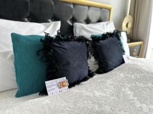 a bed with black and green pillows on it at Panorama Apartments Vienna in Vienna