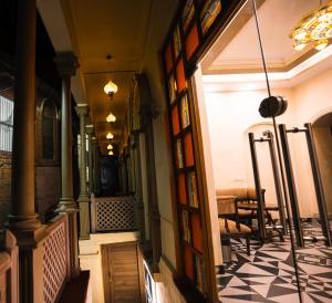 a hallway of a building with a door and a table at Captain Villa Heritage House in Varanasi