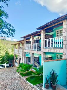 an exterior view of a house with a balcony at Pousada das Arvores in Lençóis