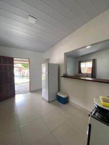 a kitchen with a refrigerator in a room at Casa em Itaúnas para temporada e carnaval in Itaúnas +8 photos