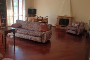 a living room with a couch and a chair at GUALANDI 25 in Rome