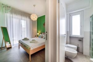 a bedroom with a bed and a bathroom with a toilet at Marina Verde in Borgio Verezzi