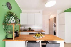 a kitchen with white cabinets and a wooden table at Marina Verde in Borgio Verezzi +16 photos