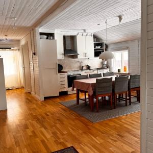 a kitchen and dining room with a table and chairs at Molnbyggen Strand, Leksand in Leksand