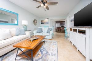 a living room with a couch and a tv at Phoenix VI 6312 in Orange Beach