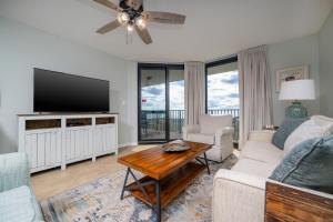 a living room with a couch and a tv at Phoenix VI 6312 in Orange Beach