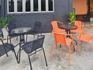 a group of tables and chairs sitting on a patio at No.10 HOSTEL- Prachuap Khiri Khan in Prachuap Khiri Khan