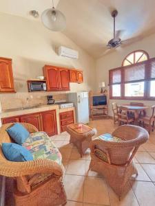 a kitchen with chairs and a couch and a table at Seville Suite in San Juan del Sur
