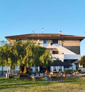 a building with tables and chairs in front of it at Villa Dei Romani - Country House in Guidonia