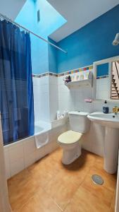a bathroom with a toilet and a sink at El Fortín de la playa by Sanlúcar Housing in Sanlúcar de Barrameda