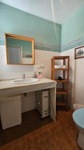 a bathroom with a sink and a mirror at El Fortín de la playa by Sanlúcar Housing in Sanlúcar de Barrameda +15 photos