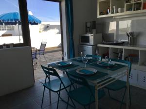 a dining room with a table and chairs and a kitchen at VILLA DE LA VISTA in Playa Blanca