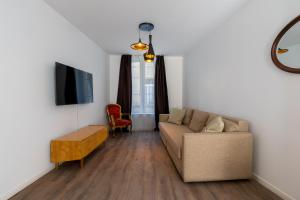 un salon avec un canapé et une télévision dans l'établissement Charmant appartement au cœur du quartier historique des Allemands, à Metz