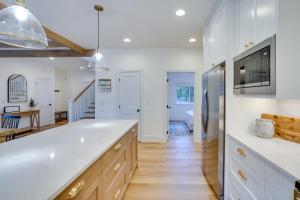 a kitchen with white countertops and a large white island at Mountain Home with Private Hot Tub and River Access! in Bend +30 photos