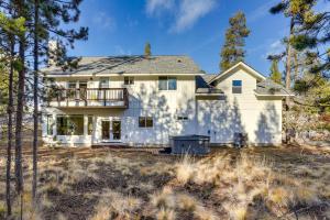 a large white house with a balcony at Mountain Home with Private Hot Tub and River Access! in Bend