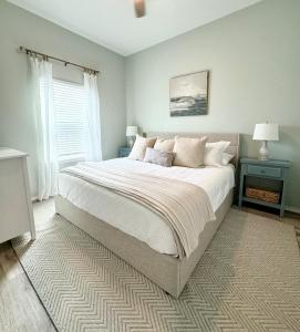 Un dormitorio con una cama grande y una ventana. en Cozy Bay Cottage with King Master Suite, Fire Pit and Pool, en Palm Harbor