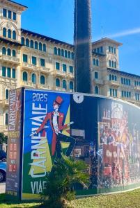 a billboard with a painting on it in front of a building at Appartamento pineta in Viareggio