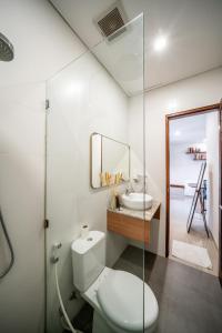 a bathroom with a toilet and a sink at Promo!! New Rosa Villa Muding, Luxury and cozy 3Bedrooms Villa in Heart of Kerobokan with Special Office Room in Kerobokan