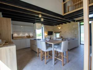 a kitchen and dining room with a table and chairs at Maison climatisée avec terrasse et Wi-Fi, animaux admis, proche Périgord Vert - FR-1-616-391 in Sorges +15 photos